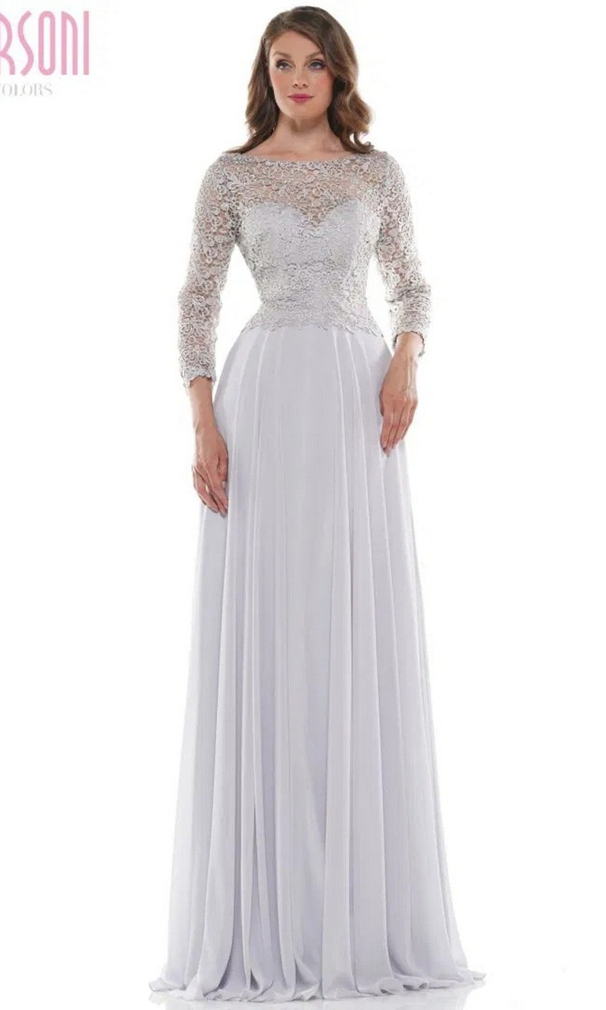 A woman poses against a plain background wearing the Marsoni M223 long formal dress in silver, featuring a lace bodice and flowing chiffon skirt.